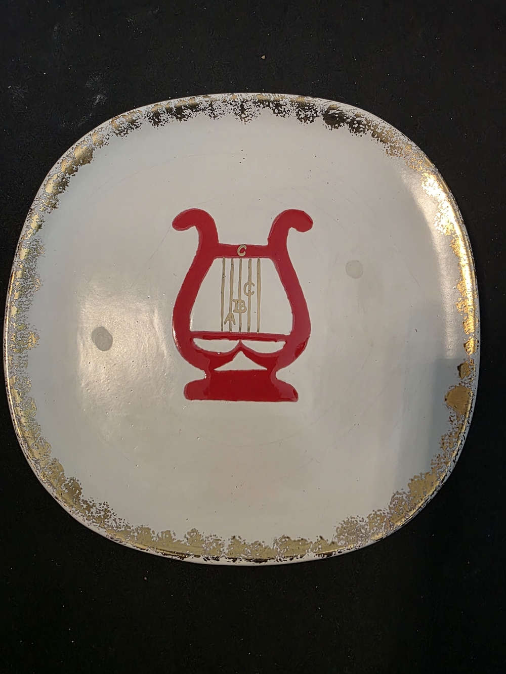 Vintage Ceramic Decorative Plate with Red Lyre Motif and Gold Rim